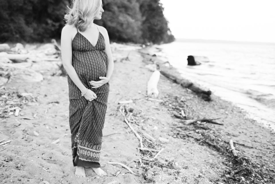 A woman poses during her maternity photo shoot