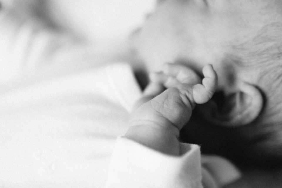 Black-and-white photo of a baby's chubby fingers