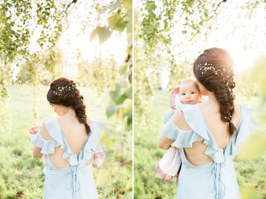 A Mom holds her baby girl wrapped in a blanket and admires her features