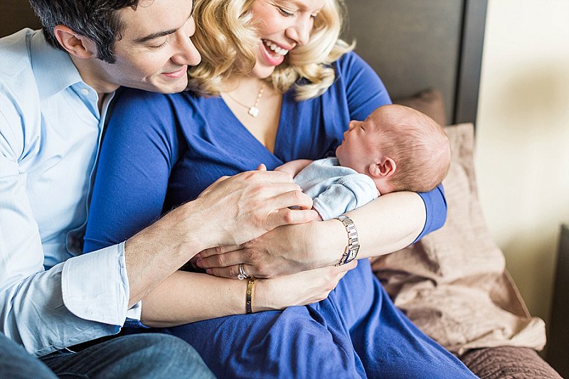 These new parents play with and coo at their newborn baby boy and are so happy