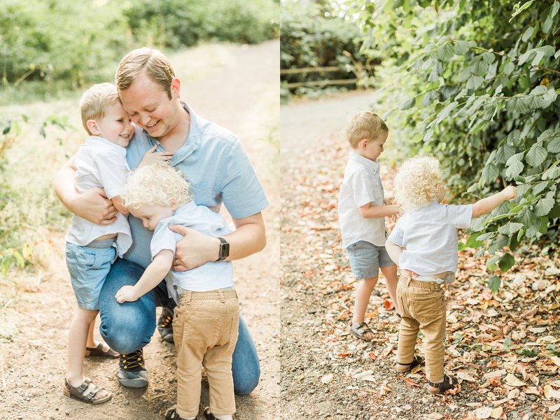 The two little boys hug their dad very tight and the dad smiles at the sweet moment