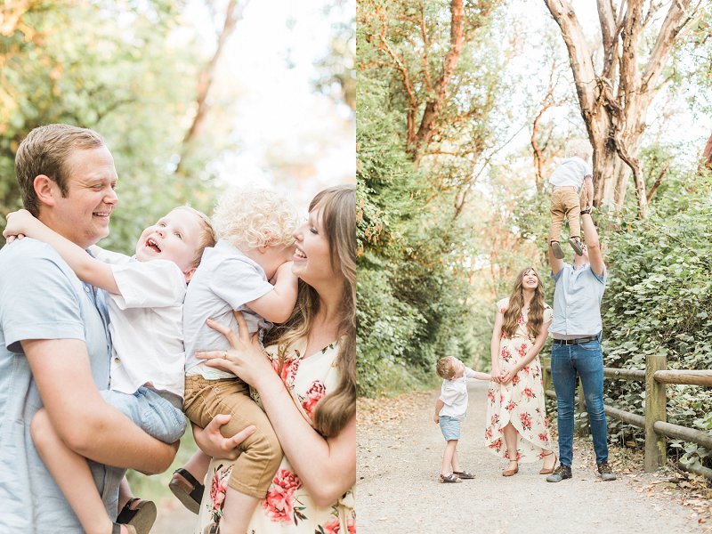 Dad tosses his toddler into the air while the rest of the family watches 