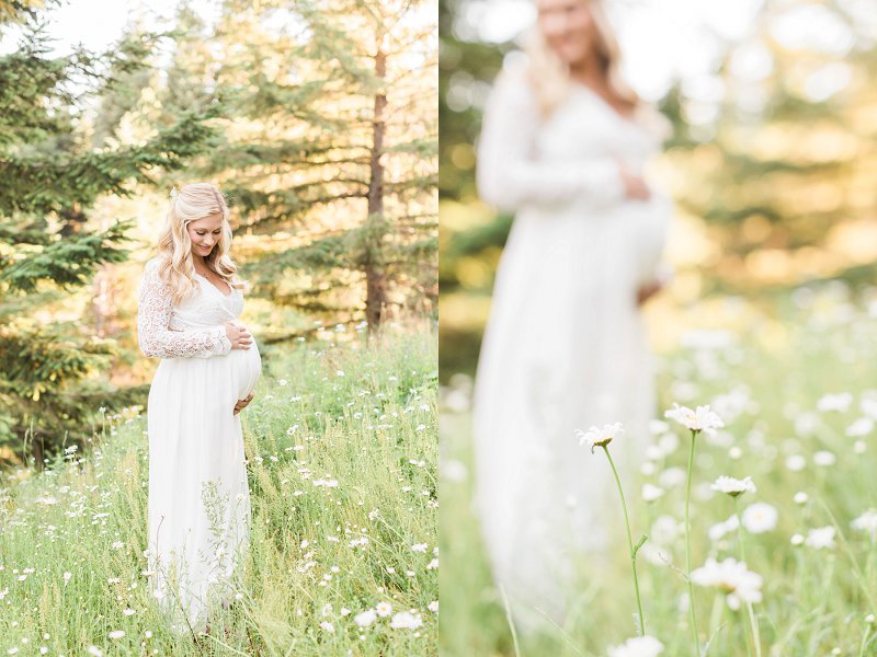 A lovely scene of a woman standing in a field of white wildflowers during her dallas maternity session