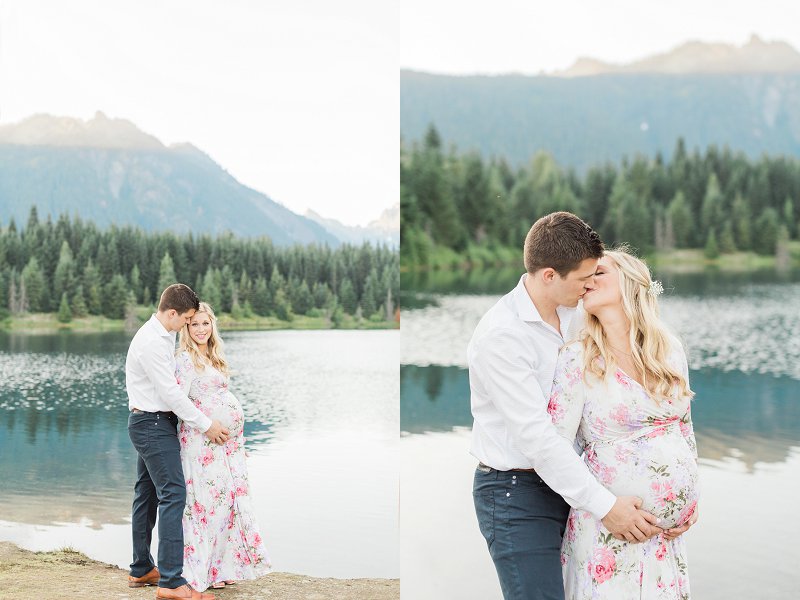 A man holds his lovely pregnant wife and kisses her in the middle of the mountains
