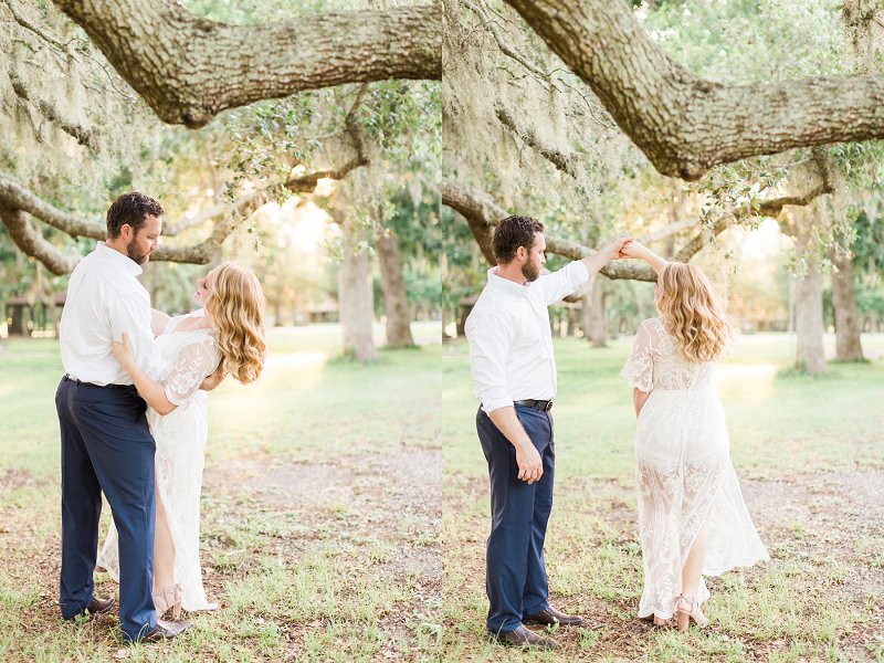 A young couple dances and twirls underneath a tree draped with Spanish moss