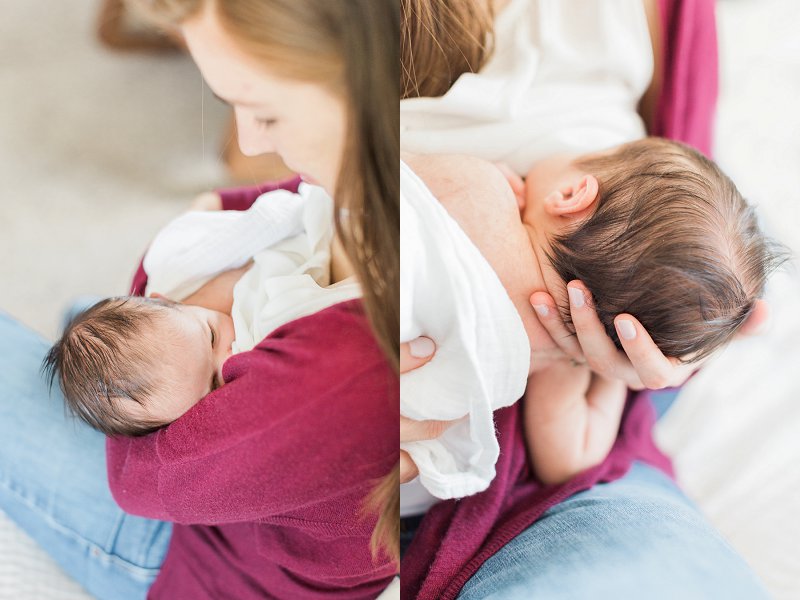 The young mother wearing a maroon cardigan breastfeeds her little newborn daughter