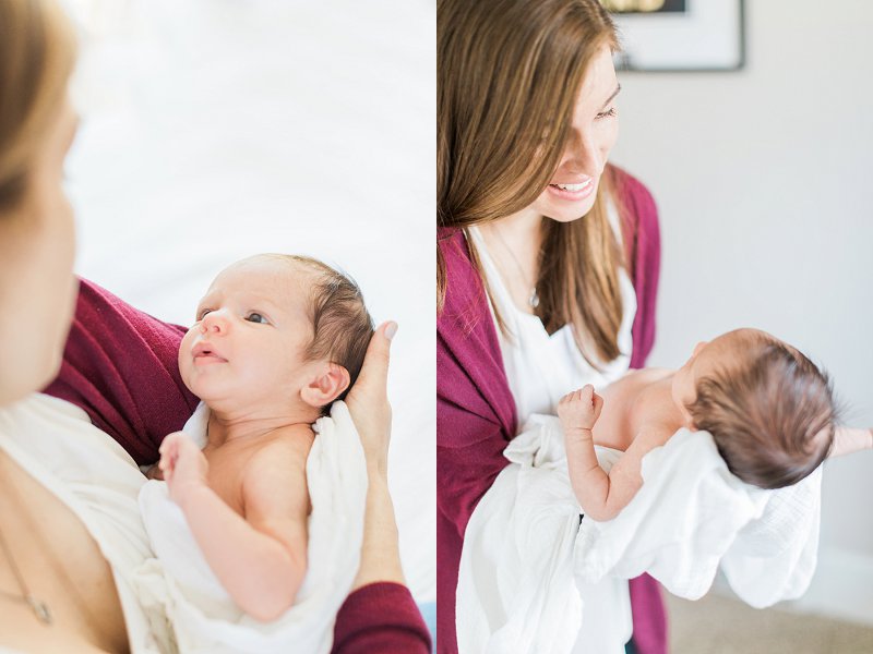 A new Mom holds her precious baby in her arms as the baby looks back up at her