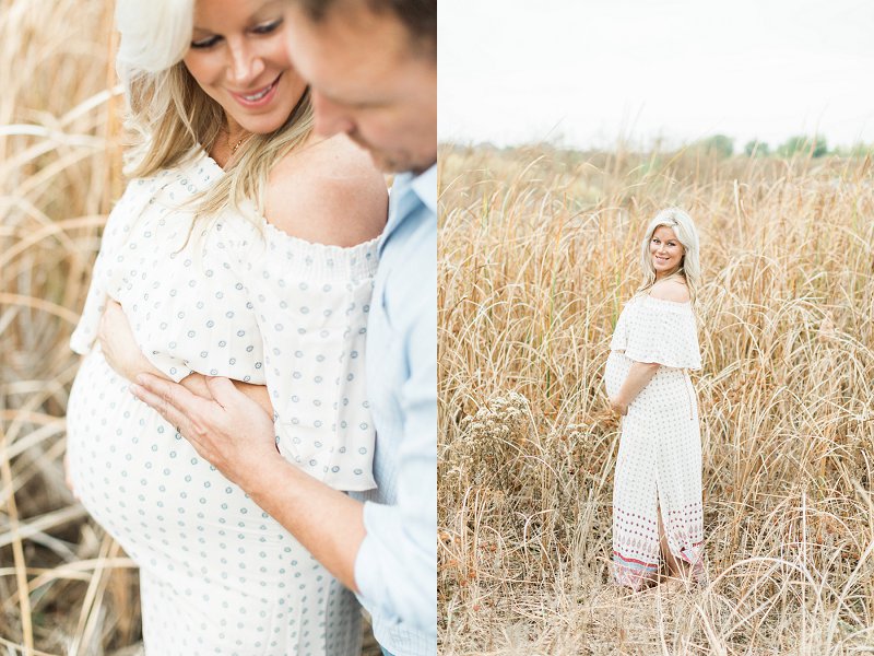 A lovely soon to be mother stands sideways with her arms around her bump and looks at the photographer over her shoulder