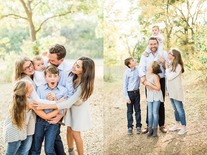 A child standing in the middle of his large family is squeezed by their group hug and makes a surprised face