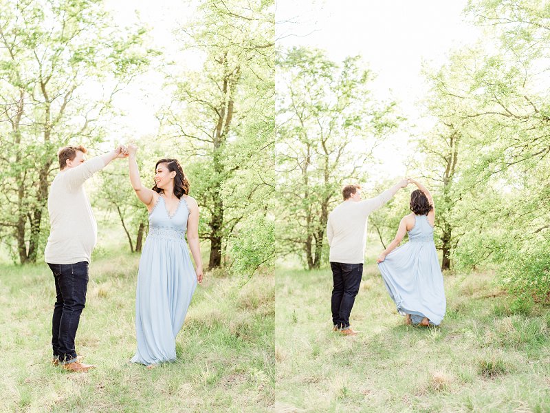 The man wearing a cream shirt spins his wife like a princess in her blue dress
