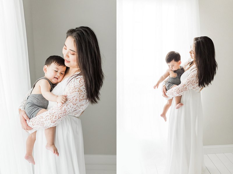 A lovely motherhood portrait of a mother tenderly holding her young son in an all white studio
