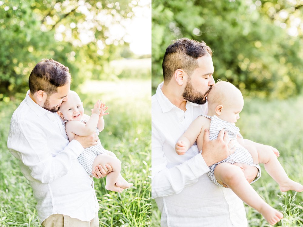 The young Father leans in and closes his eyes as he kisses his son on the head