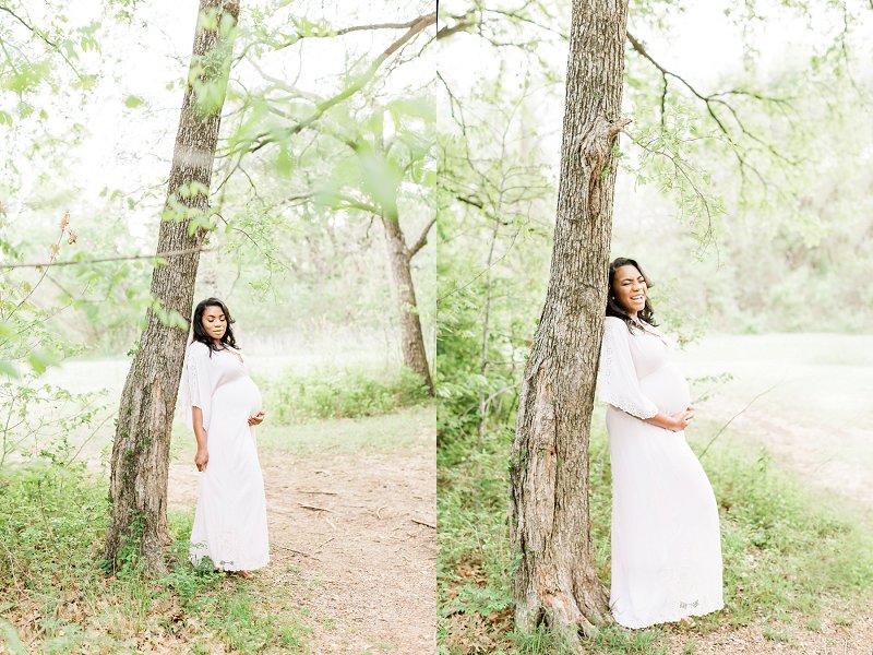 A lovely pregnant woman models during her photo session in a forest