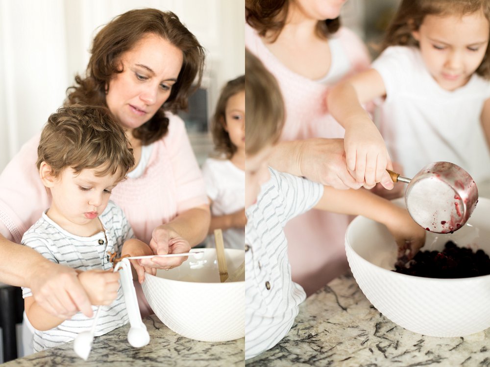 Grandma carefully helps her two year old grandson fill a measuring spoon while he concentrates