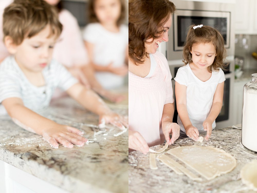 While the other two look on the little boy spreads flour all over the kitchen counter 