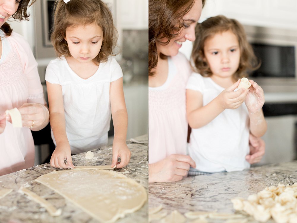 the four year old little girl concentrates as her Mom helps her make rosettes out of pie crust