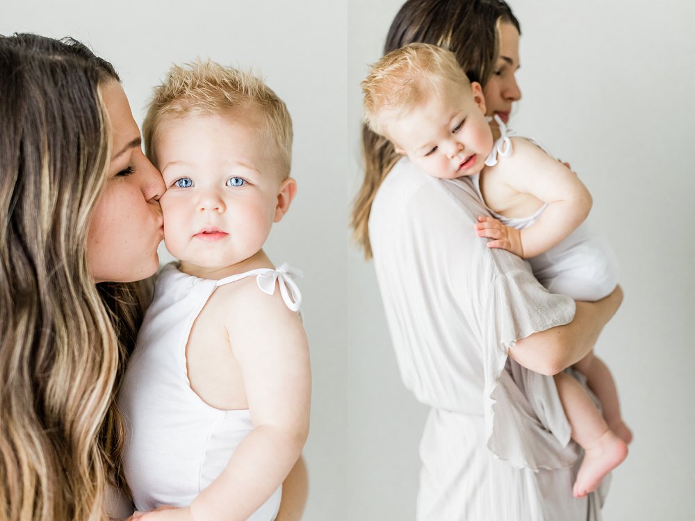Mom gives her little boy's very chubby cheek a  kiss as he looks at the camera
