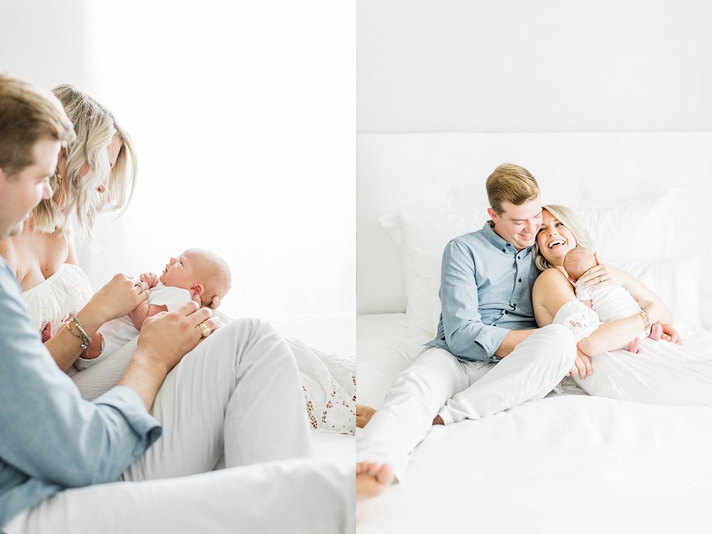 Dad and Mom smiling at newborn baby in light and airy newborn photos