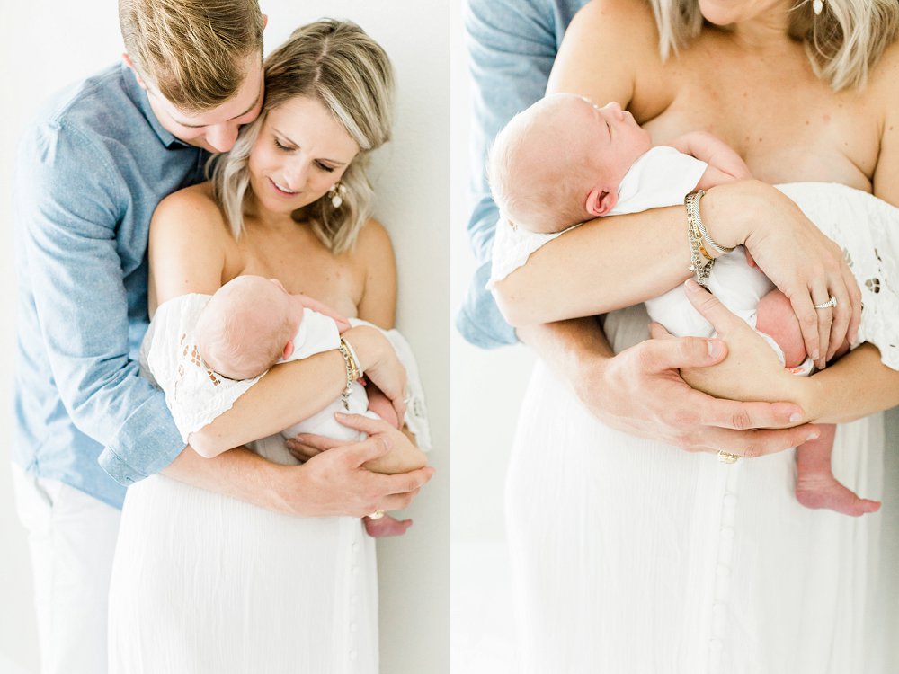 Dad and Mom holding newborn baby in family photos