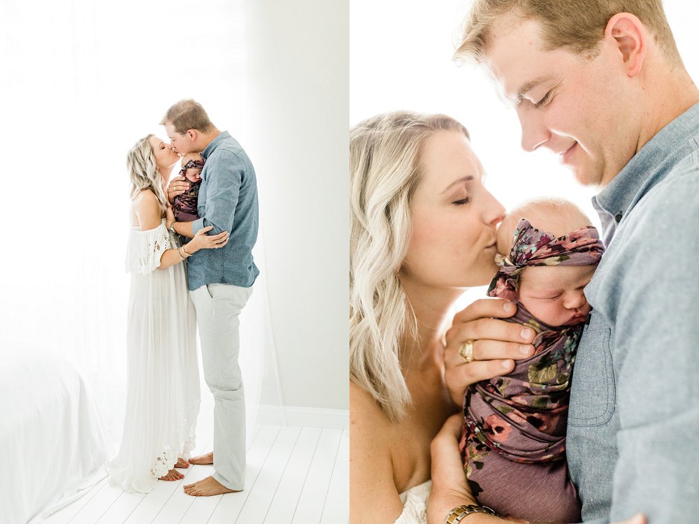 Dad and Mom kiss each other and newborn baby in precious newborn photos