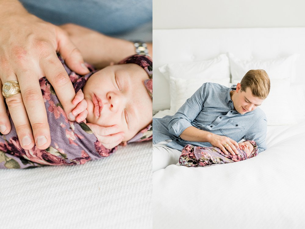 Newborn holds Dad's finger in white newborn photos