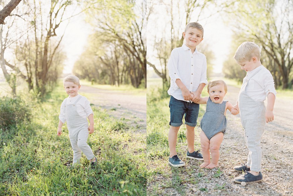 Three brothers holding hands and smiling during their session with Family Photographer near Dallas