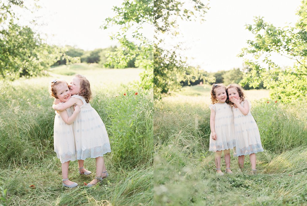 Little girls wrap their arms around each other and almost fall over from laughing so hard